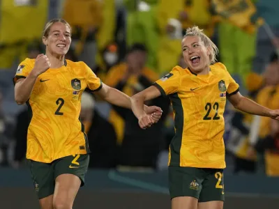 Australia's Courtney Nevin, left, and Charlotte Grant celebrate after the Women's World Cup round of 16 soccer match between Australia and Denmark at Stadium Australia in Sydney, Australia, Monday, Aug. 7, 2023. Australia won 2-0. (AP Photo/Mark Baker)