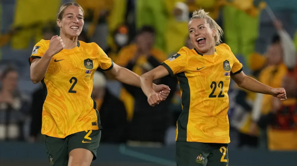 Australia's Courtney Nevin, left, and Charlotte Grant celebrate after the Women's World Cup round of 16 soccer match between Australia and Denmark at Stadium Australia in Sydney, Australia, Monday, Aug. 7, 2023. Australia won 2-0. (AP Photo/Mark Baker)
