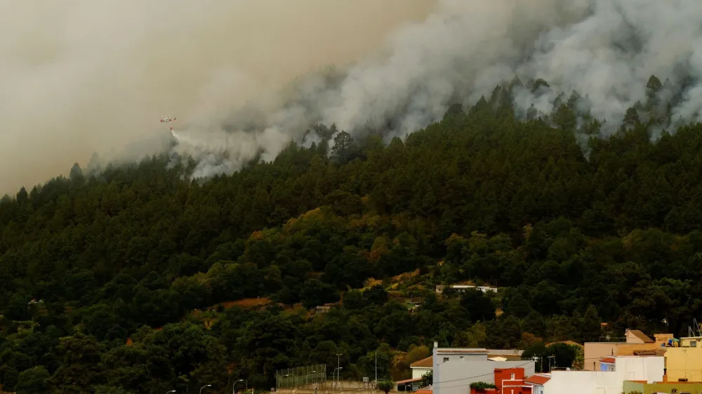 A firefighting helicopter makes a water drop near Aguamansa, as wildfires rage out of control on the island of Tenerife, Canary Islands, Spain August 18, 2023. REUTERS/Nacho Doce