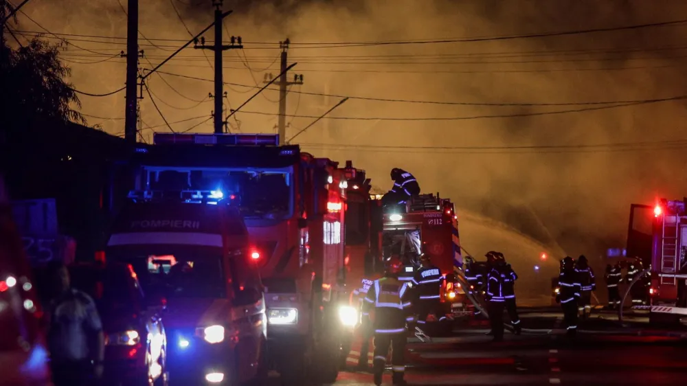 Fire fighters work as flames rise after an explosion at a LPG station in Crevedia, near Bucharest, Romania, August 26, 2023. Inquam Photos/Octav Ganea via REUTERS ATTENTION EDITORS - THIS IMAGE HAS BEEN SUPPLIED BY A THIRD PARTY. ROMANIA OUT. NO COMMERCIAL OR EDITORIAL SALES IN ROMANIA