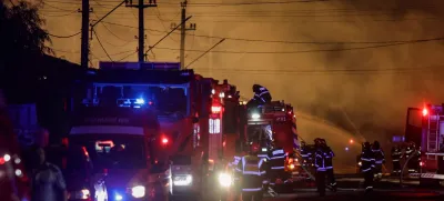 Fire fighters work as flames rise after an explosion at a LPG station in Crevedia, near Bucharest, Romania, August 26, 2023. Inquam Photos/Octav Ganea via REUTERS ATTENTION EDITORS - THIS IMAGE HAS BEEN SUPPLIED BY A THIRD PARTY. ROMANIA OUT. NO COMMERCIAL OR EDITORIAL SALES IN ROMANIA