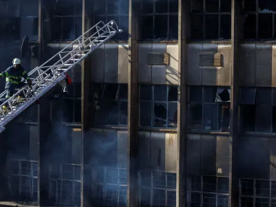 A firefighter works at the scene of a deadly blaze, in Johannesburg, South Africa August 31, 2023. REUTERS/Siphiwe Sibeko