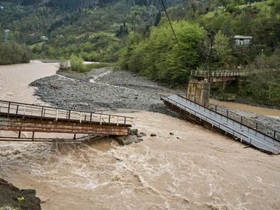 A bridge over a mountain river destroyed by water.