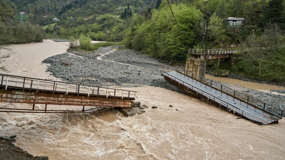 A bridge over a mountain river destroyed by water.