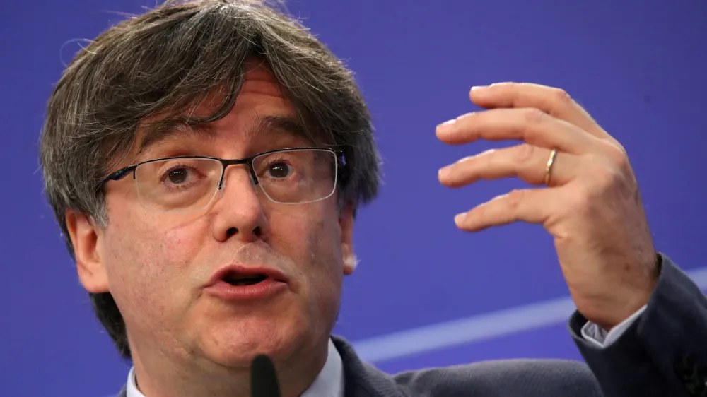 FILE PHOTO: Catalan MEP Carles Puigdemont gestures during a joint news conference with Catalan MEPs Antoni Comin and Clara Ponsati regarding their immunity at the European Parliament, in Brussels, Belgium June 3, 2021. REUTERS/Yves Herman/File Photo