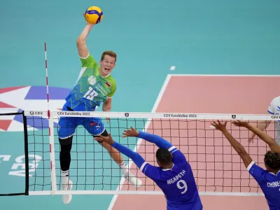 Slovenia's Rok Mozic, left, in action during the Men's European Volleyball bronze medal final between France and Slovenia, in Rome, Saturday, Sept. 16, 2023. (AP Photo/Andrew Medichini)