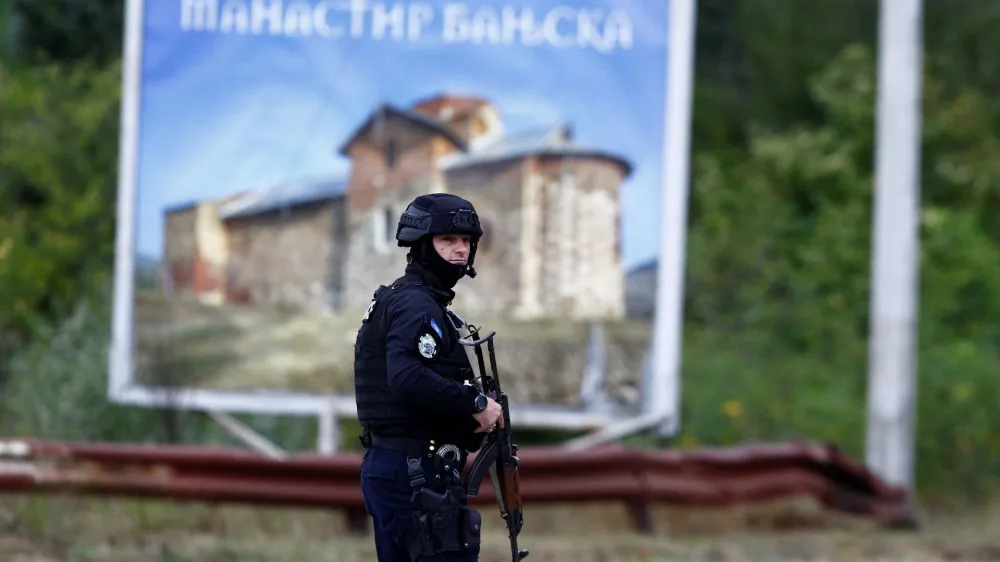 A Kosovo police officer stands guard on a road to Banjska monastery, in the aftermath of a shooting incident, near Zvecan, Kosovo September 25, 2023. REUTERS/Ognen Teofilovski