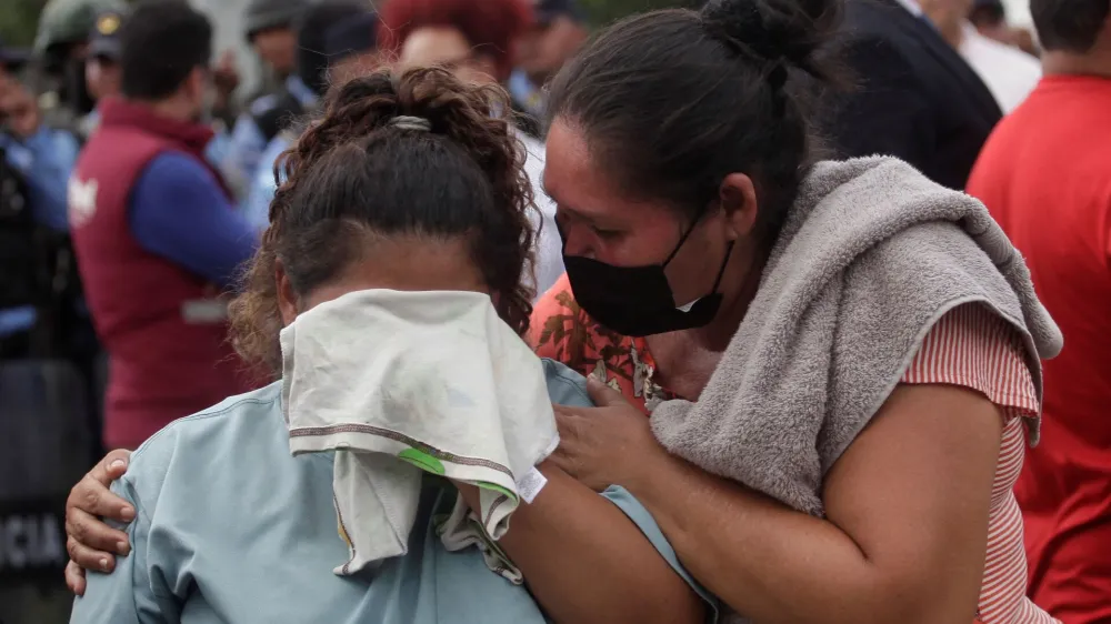 The relative of an inmate reacts while another person tries to comfort her as they wait for news about their loved ones outside the Centro Femenino de Adaptacion Social (CEFAS) women's prison following deadly riot in Tamara, on the outskirts of Tegucigalpa, Honduras, June 20, 2023. REUTERS/Fredy Rodriguez