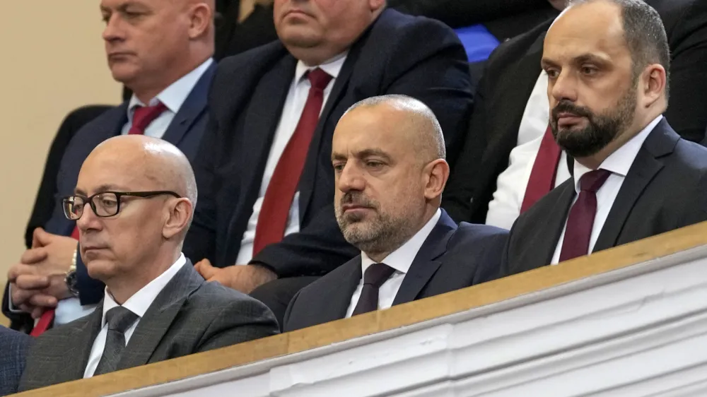 Politician and wealthy businessman Milan Radoicic, center, Serb List leader Goran Rakic, left, and former mayor of the Serb part of the ethnically divided town of Mitrovica Milan Radojevic attend a special session of Serbia's parliament about the negotiating process with Kosovo, in Belgrade, Serbia on Feb. 2, 2023. Serbian police on Tuesday detained an ethnic Serb leader Milan Radoicic from Kosovo who was the alleged organizer behind a recent shootout with Kosovo police that left four people dead and sent tensions soaring in the region. (AP Photo/Darko Vojinovic, File)