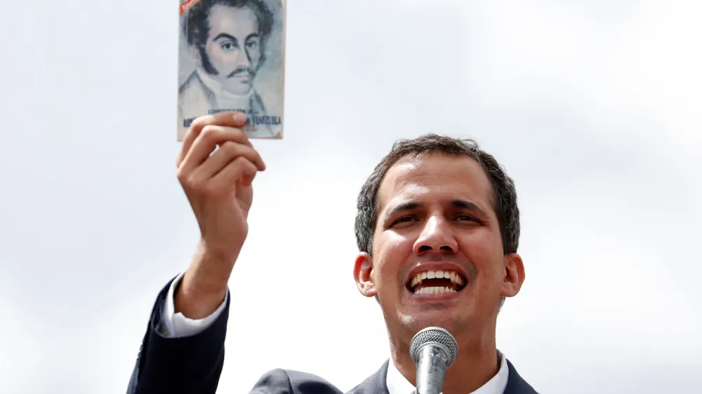 Juan Guaido, President of Venezuela's National Assembly, holds a copy of Venezuelan constitution during a rally against Venezuelan President Nicolas Maduro's government and to commemorate the 61st anniversary of the end of the dictatorship of Marcos Perez Jimenez in Caracas, Venezuela January 23, 2019. REUTERS/Carlos Garcia Rawlins