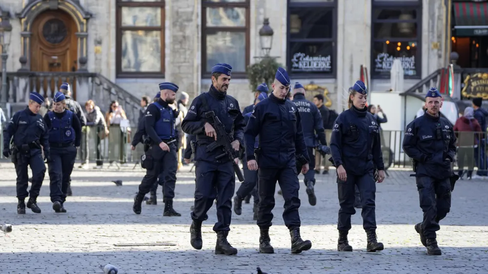 Belgian Police patrol the Grand Place in central Brussels, Tuesday, Oct. 17, 2023, following the shooting of two Swedish soccer fans who were shot by a suspected Tunisian extremist on Monday night. Police in Belgium have shot dead a suspected Tunisian extremist accused of killing two Swedish soccer fans in a brazen attack on a Brussels street before disappearing into the night on Monday. (AP Photo/Martin Meissner)