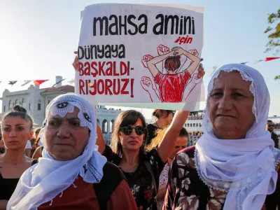 FILE PHOTO: Women take part in a rally on the first anniversary of the death of Mahsa Amini which prompted protests across the country, in Istanbul, Turkey September 16, 2023. Banner reads, "We revolt against world for Mahsa Amini". REUTERS/Dilara Senkaya/File Photo