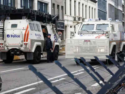 An officer stands next to an armored vehicle, on the day of European Union leaders summit, in Brussels, Belgium October 26, 2023. REUTERS/Yves Herman
