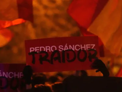 A sign reading 'Pedro Sanchez, Traitor' is held up during a protest by right wing demonstrators near the national headquarters of Spain's Socialist Party in Madrid, Spain, Tuesday, Nov. 7, 2023. The Spanish capital saw its second night in a row of clashes between police and protesters who oppose negotiations between Spain's acting government and Catalan separatist parties over a&nbsp;possible amnesty&nbsp;for thousands involved in Catalonia's independence movement. (AP Photo/Paul White)