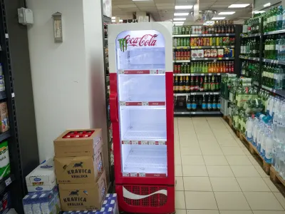 An empty CocaCola refrigerator is seen at a grocery shop in Zagreb, Croatia, Wednesday, Nov. 8, 2023. Authorities in Croatia on Wednesday recommended people drink only tap water as they investigated reports of several cases of people getting sick and suffering injuries allegedly after consuming bottled beverages. They did not say which products were being withdrawn, but photos on social media from shops suggested they were Coca-Cola brands. (AP Photo/Darko Bandic)