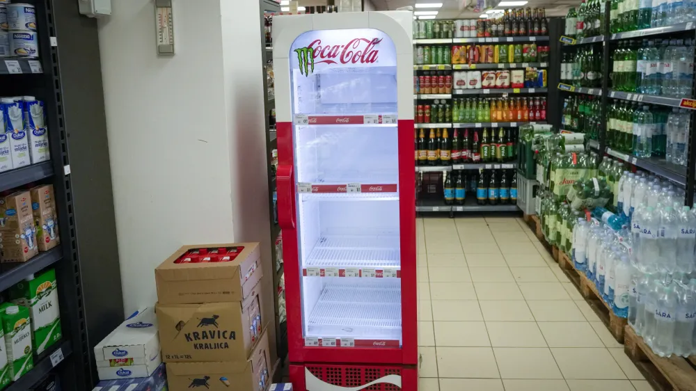 An empty CocaCola refrigerator is seen at a grocery shop in Zagreb, Croatia, Wednesday, Nov. 8, 2023. Authorities in Croatia on Wednesday recommended people drink only tap water as they investigated reports of several cases of people getting sick and suffering injuries allegedly after consuming bottled beverages. They did not say which products were being withdrawn, but photos on social media from shops suggested they were Coca-Cola brands. (AP Photo/Darko Bandic)