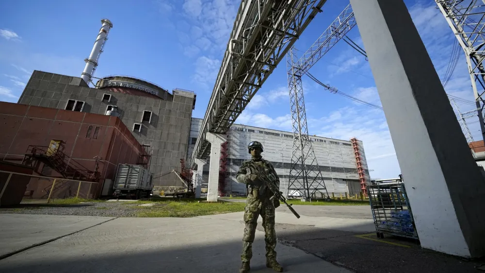 FILE - A Russian serviceman guards an area of the Zaporizhzhia Nuclear Power Station in territory under Russian military control, southeastern Ukraine, on May 1, 2022. Ukraine and Russia accused each other Wednesday, July 5, 2023, of planning to attack the power plant, which is occupied by Russian troops, but neither side provided evidence to support their claims. (AP Photo, File)
