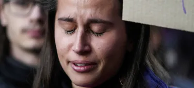 A student cries as she participates in a flash mob 'A minute of noise for Giulia' outside the Statale University, in Milan, Italy, Wednesday, Nov. 22, 2023. Italy has erupted in outrage over the death of a young woman, allegedly at the hands of her possessive ex-boyfriend. It's the latest in a series of cases of gender-based violence that has claimed the lives of more than 50 women so far this year in Italy. (AP Photo/Luca Bruno)
