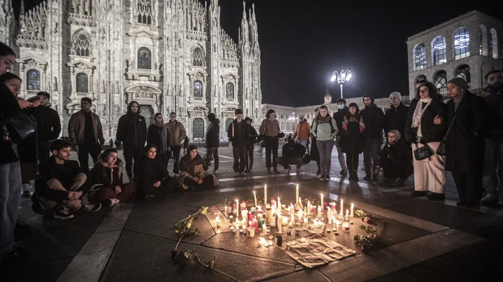 FILE - People attend a candlelight vigil for 22-year-old Giulia Cecchettin, allegedly killed at the hands of her possessive ex-boyfriend, in front of the Milan Duomo Cathedral, Italy, Sunday, Nov. 19, 2023. Outrage over violence against women is mounting in Italy, with students leading the way. Young people across the country have taken to pounding on classroom desks in unison to demand an end to the slayings of women by men and to root out corrosive, patriarchal attitudes that have long been a part of Italian society. Opposition lawmakers did the same in parliament. (Marco Ottico/LaPresse via AP, file)