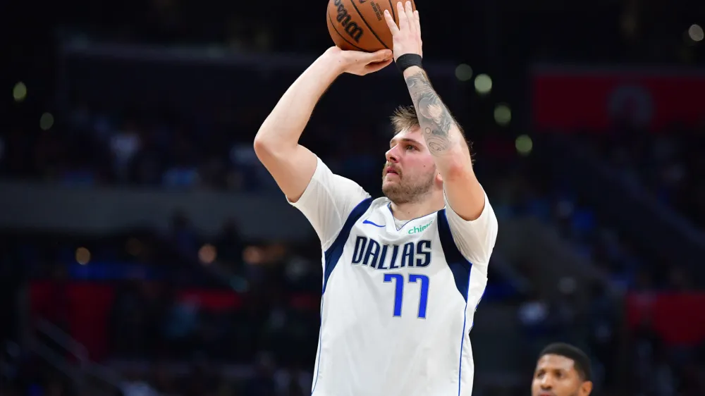 Nov 25, 2023; Los Angeles, California, USA; Dallas Mavericks guard Luka Doncic (77) shoots against the Los Angeles Clippers during the second half Crypto.com Arena. Mandatory Credit: Gary A. Vasquez-USA TODAY Sports
