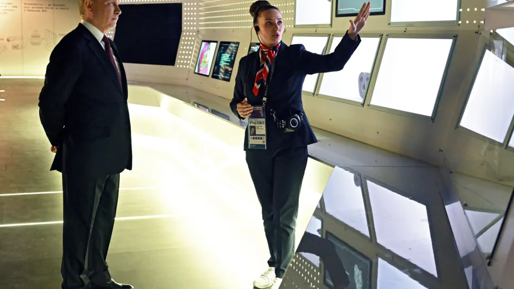 Russian President Vladimir Putin, left, visits the International exhibition "Russia" at VDNKh (The Exhibition of Achievements of National Economy) in Moscow, Russia, Monday, Dec. 4, 2023. (Stanislav Krasilnikov, Sputnik, Kremlin Pool Photo via AP)