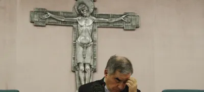 FILE - Cardinal Angelo Becciu talks to journalists during a press conference in Rome, Friday, Sept. 25, 2020. Lawyers for the once-powerful cardinal have accused Vatican prosecutors of being "prisoners to their completely shattered theory" in closing arguments of a two-year trial. Becciu is on trial along with nine other people in a case that is focused on the Vatican's 350 million-euro investment in a London property. (AP Photo/Gregorio Borgia)