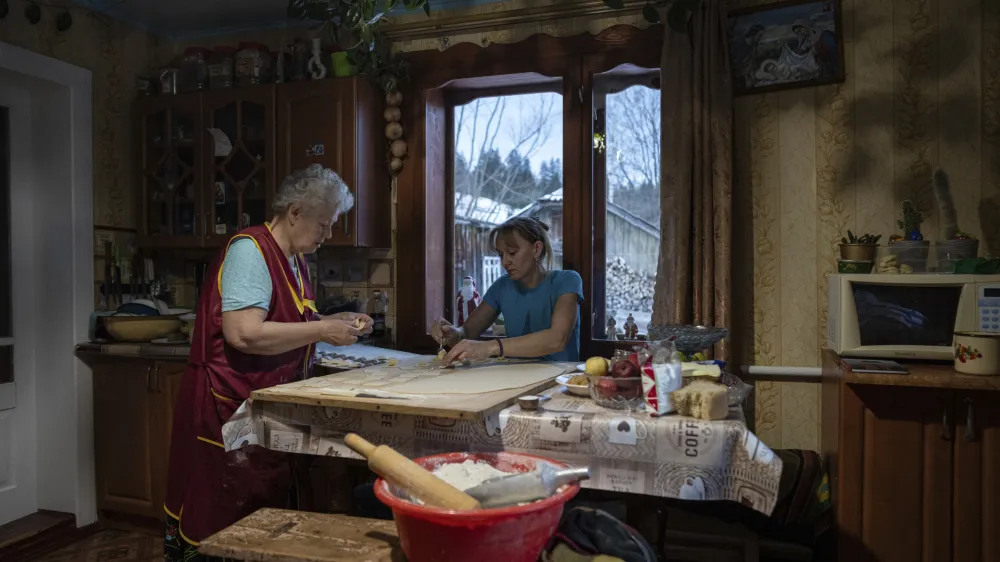 Women make dumplings for a dinner before Christmas celebration in Kryvorivnia village, Ukraine, Sunday, Dec. 24, 2023. (AP Photo/Evgeniy Maloletka)