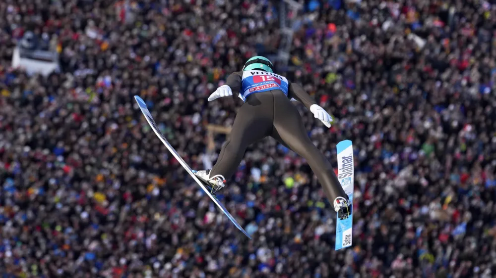 Lovro Kos, of Slovenia, soars through the air during his first round jump at the second stage of the 72th Four Hills ski jumping tournament in Garmisch-Partenkirchen, Germany, Monday, Jan. 1, 2024. (AP Photo/Matthias Schrader)