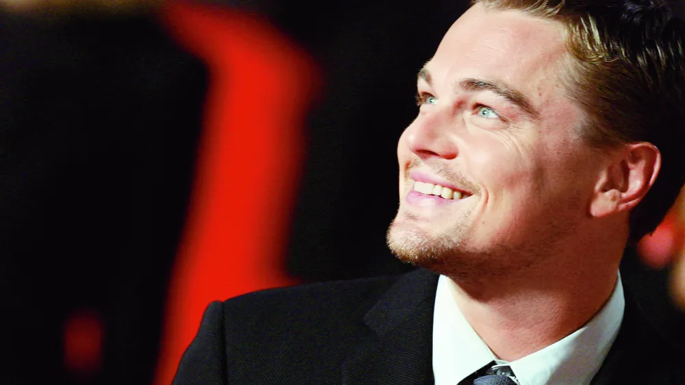 ** ALTERNATIVE CROP ** Actor Leonardo Di Caprio smiles as he arrives at Rome's Auditorium, Sunday, Oct. 15, 2006, to present the movie "The departed", at the first ever edition of the Rome "Festa del Cinema" Film Festival. (AP Photo/Andrew Medichini)na 28cc