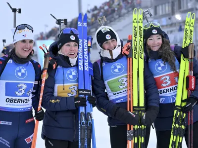 From left, Julia Simon from France, Sophie Chauveau from France, Justine Braisaz-Bouchet from France and Lou Jeanmonnot from France celebrate their victory after the Biathlon women's relay 4 x 6 km World Cup in Oberhof, Germany, Sunday, Jan. 7, 2024. (Martin Schutt/dpa via AP)