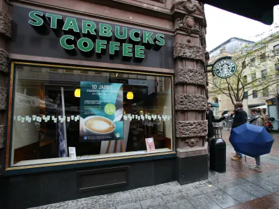 Pedestrians stand next a branch of Starbucks in Frankfurt October 30, 2012. The Seattle-based group, with a market capitalisation of  billion, is the second-largest restaurant or cafe chain globally after McDonald's. REUTERS/Ralph Orlowski (GERMANYBUSINESS - Tags: BUSINESS FOOD)