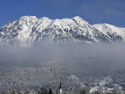 A view of mountains with the church of St. John the Baptist, bottom centre, in Oberstdorf, Bavaria, Germany, Jan. 9, 2024. (Karl-Josef Hildenbrand/dpa/dpa via AP)