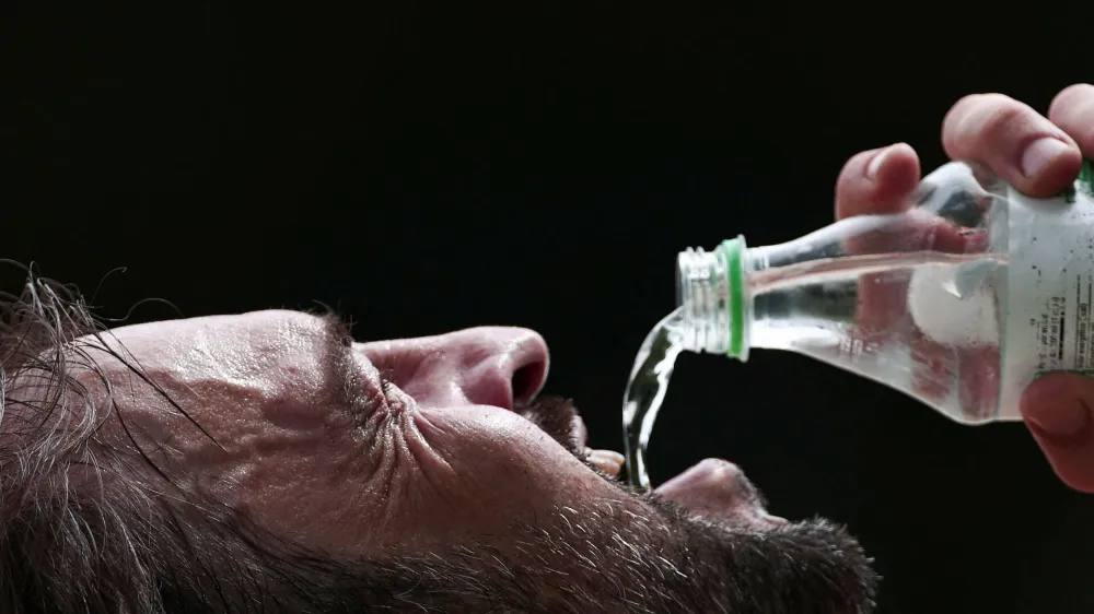 A man drinks water in a park during the summer in Porto Alegre, Brazil, January 8, 2024. REUTERS/Diego&nbsp;Vara