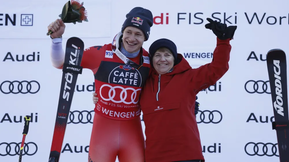 Switzerland's Marco Odermatt and Swiss Federal president Viola Amherd, celebrate after an alpine ski, men's World Cup downhill race, in Wengen, Switzerland, Saturday, Jan. 13, 2024. (AP Photo/Alessandro Trovati)