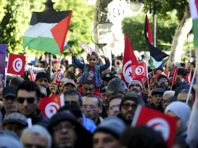 People commemorate the 13th anniversary of the Tunisian uprising in Tunis, Sunday, Jan. 14, 2024. (AP Photo/Hassene Dridi)