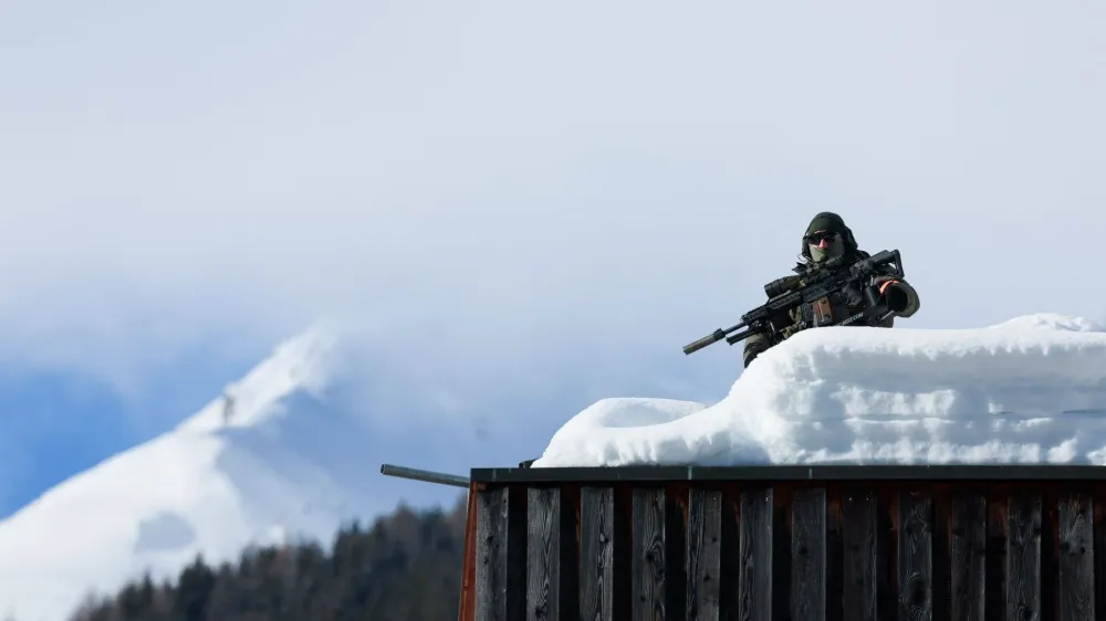 A police officer works on a roof ahead of the annual meeting of the World Economic Forum (WEF) in Davos, Switzerland, January 15, 2024. REUTERS/Denis Balibouse