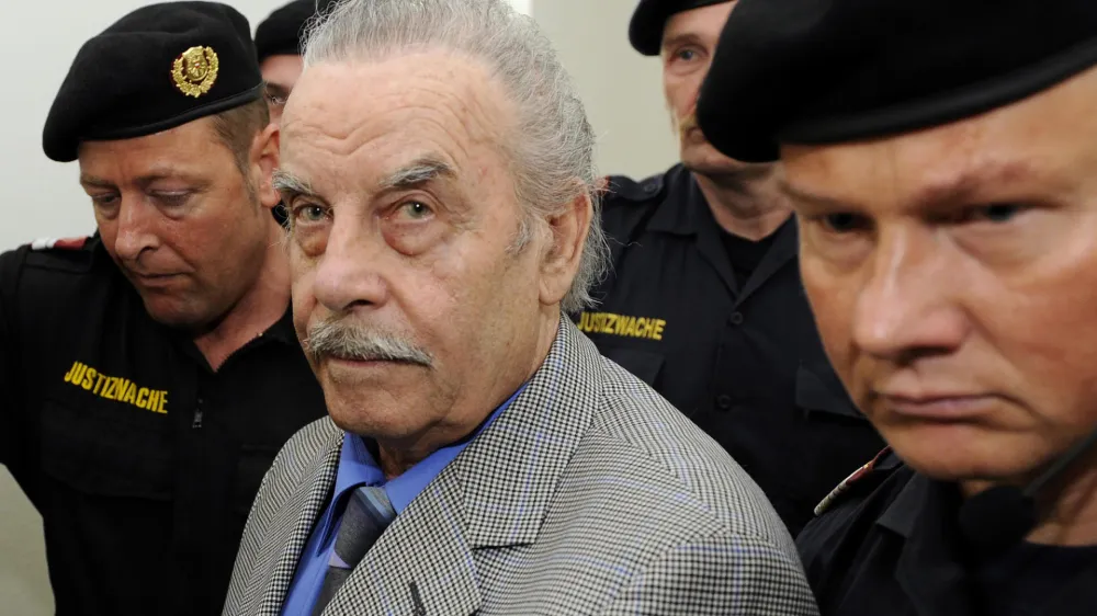 Defendant Josef Fritzl, center, is escorted to the fourth day of his trial in the provincial courthouse in St. Poelten, Austria, Thursday, March 19, 2009. An Austrian prosecutor is urging a jury to hand down a life sentence to Josef Fritzl, who imprisoned his daughter in a windowless cell for 24 years and fathered her seven children. (AP Photo/Robert Jaeger, Pool) ** EDITORIAL USE ONLY **