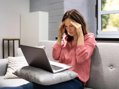 2H2GX51 Depressed Business Woman In Home Office With Headache