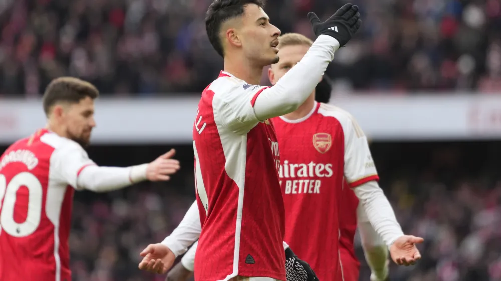 Arsenal's Gabriel Martinelli, centre, celebrates with teammates after scoring his side's fifth goal during the English Premier League soccer match between Arsenal and Crystal Palace at Emirates Stadium in London, Saturday, Jan. 20, 2024. (AP Photo/Kirsty Wigglesworth)