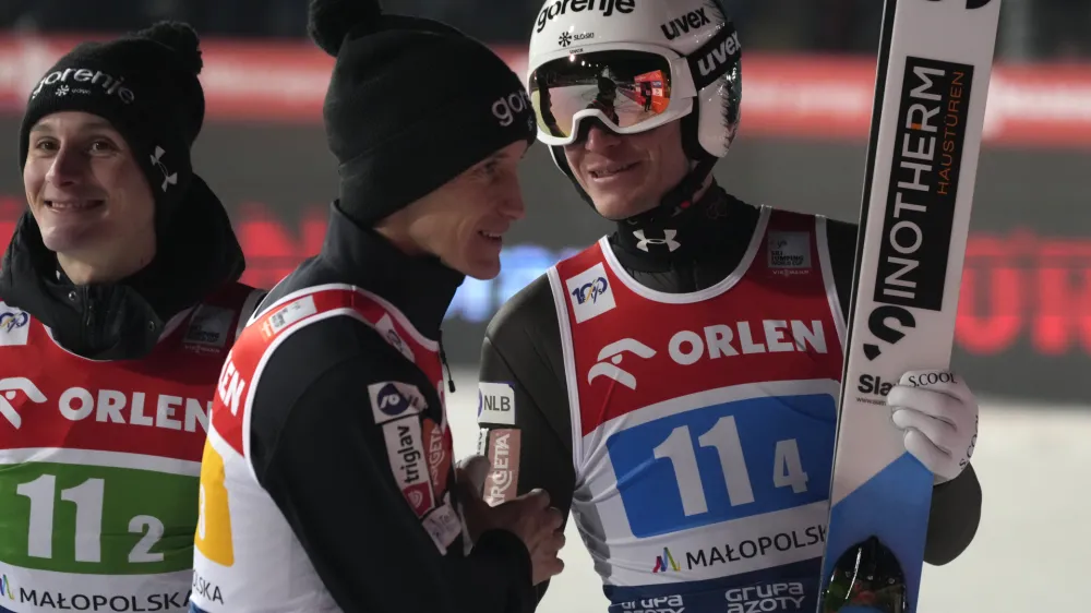 Slovenia's Anze Lanisek, right, smiles with teammates after the team competition of the Ski Jumping World Cup in Zakopane, Poland, Saturday, Jan. 20, 2024. (AP Photo/Czarek Sokolowski)