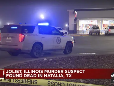 In this image taken from video provided by KSAT-TV ABC 12, authorities stage at a gas station in Natalia, Texas, late Monday, Jan. 22, 2024. A man suspected of shooting and killing multiple people in suburban Chicago fatally shot himself at the gas station after a confrontation with law enforcement officials, police said. (KSAT-TV ABC 12 via AP)