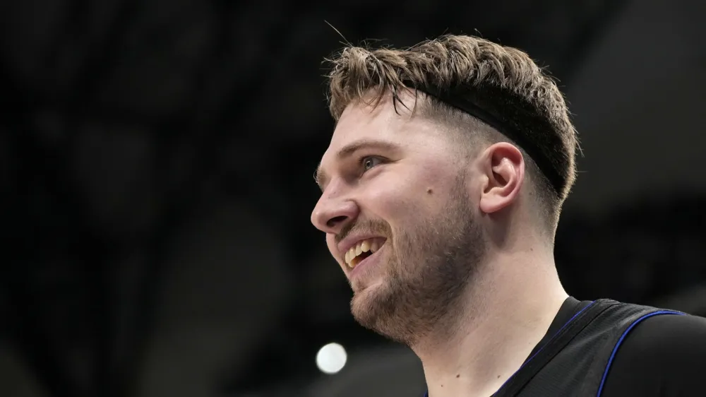 Dallas Mavericks guard Luka Doncic smiles after sinking a three-point basket in the first half of an NBA basketball game against the Phoenix Suns in Dallas, Wednesday, Jan. 24, 2024. (AP Photo/Tony Gutierrez)