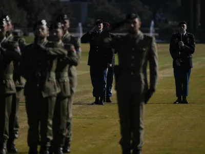 US Army paratroopers stand behind Italian Army soldiers during a ceremony at the Sicily-Rome American Cemetery to commemorate the 80th Anniversary of the landing of allied forces on the shores of Anzio and Nettuno, in Nettuno, central Italy, Wednesday, Jan. 24, 2024. (AP Photo/Gregorio Borgia)