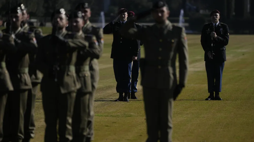 US Army paratroopers stand behind Italian Army soldiers during a ceremony at the Sicily-Rome American Cemetery to commemorate the 80th Anniversary of the landing of allied forces on the shores of Anzio and Nettuno, in Nettuno, central Italy, Wednesday, Jan. 24, 2024. (AP Photo/Gregorio Borgia)