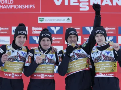 Slovenia's Timi Zajc, Domen Prevc, Peter Prevc, and Lovro Kos, from left, pose with their medals after winning the Men Team competition at the ski flying world championships, at the Kulmkogel mountain in Bad Mitterndorf, Austria, Sunday, Jan. 28, 2024. (AP Photo/Matthias Schrader)