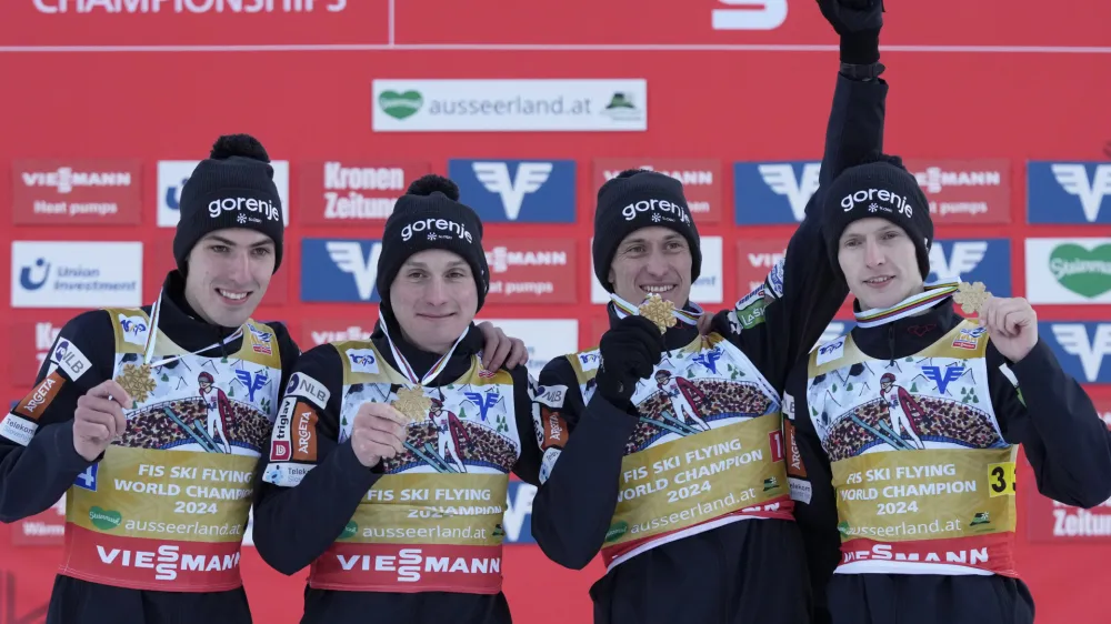 Slovenia's Timi Zajc, Domen Prevc, Peter Prevc, and Lovro Kos, from left, pose with their medals after winning the Men Team competition at the ski flying world championships, at the Kulmkogel mountain in Bad Mitterndorf, Austria, Sunday, Jan. 28, 2024. (AP Photo/Matthias Schrader)