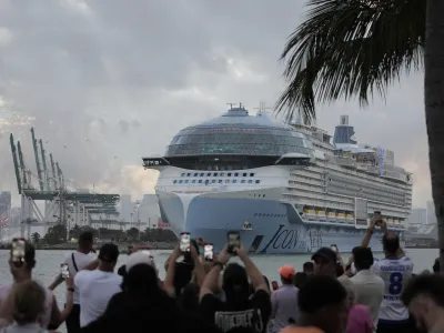 People film from South Pointe Park, as Icon of the Seas, the world's largest cruise ship, sails out of PortMiami on its first public cruise, in Miami Beach, Fla., Saturday, Jan. 27, 2024. (AP Photo/Rebecca Blackwell)