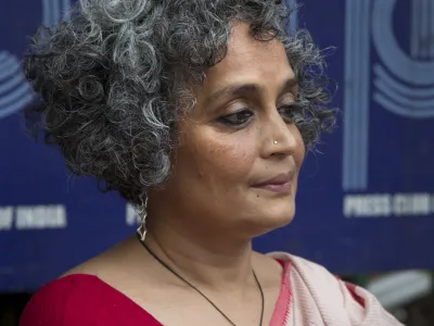 Writer activist Arundhati Roy sits for a press conference opposing the arrests this week of five prominent rights activists, in New Delhi, India, Thursday, Aug. 30, 2018. (AP Photo/Manish Swarup)