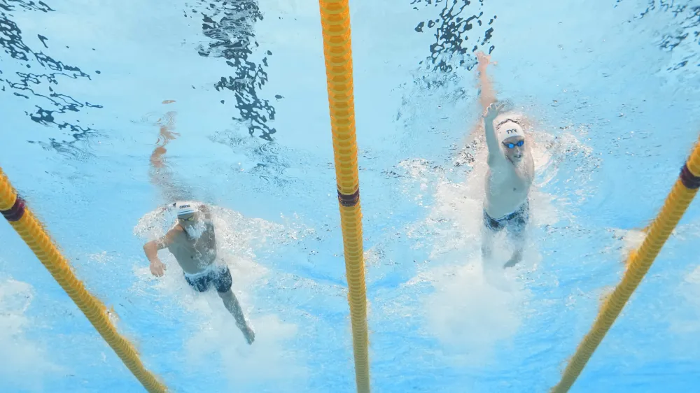 Vlad-Stefan Stancu of Romania, left, and David Aubry France, right, compete in the men's 400-meter freestyle heat at the World Aquatics Championships in Doha, Qatar, Sunday, Feb. 11, 2024. (AP Photo/Lee Jin-man)
