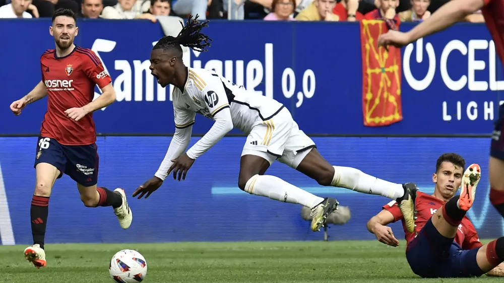 Real Madrid's David Alaba is fouled by Osasuna's Lucas Torrom during the Spanish La Liga soccer match between Osasuna and Real Madrid at the El Sadar stadium in Pamplona, Spain, Saturday, March 16, 2023. (AP Photo/Alvaro Barrientos)
